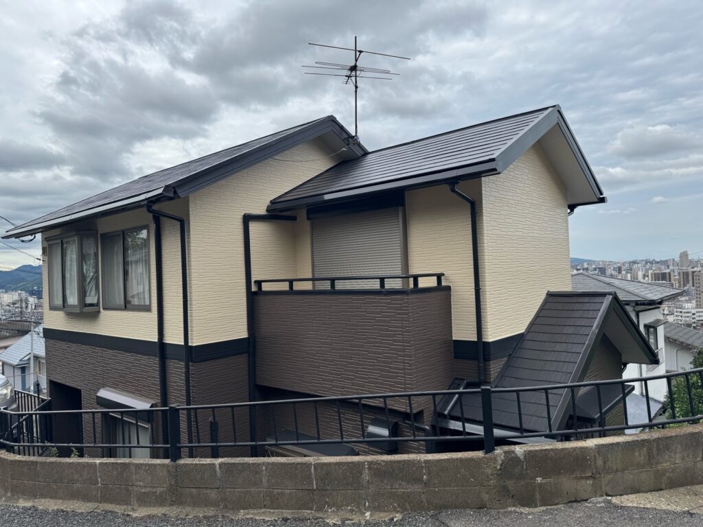 屋根・外壁塗装工事が完了した2階建て住宅。濃色の屋根とツートンカラーの外壁